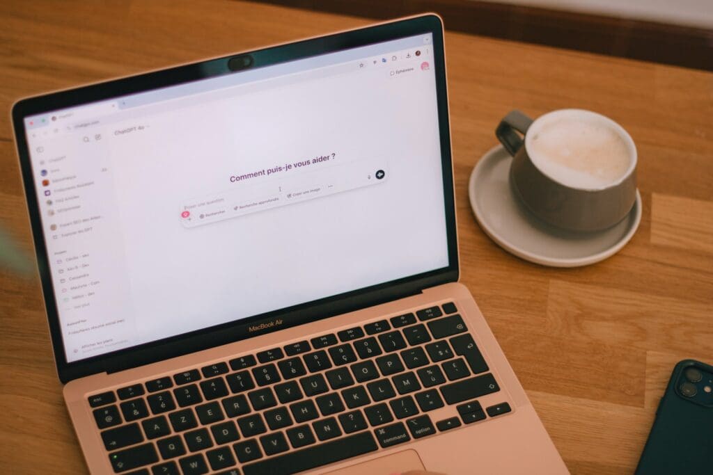 chatgpt search on a laptop that is sitting on a desk.