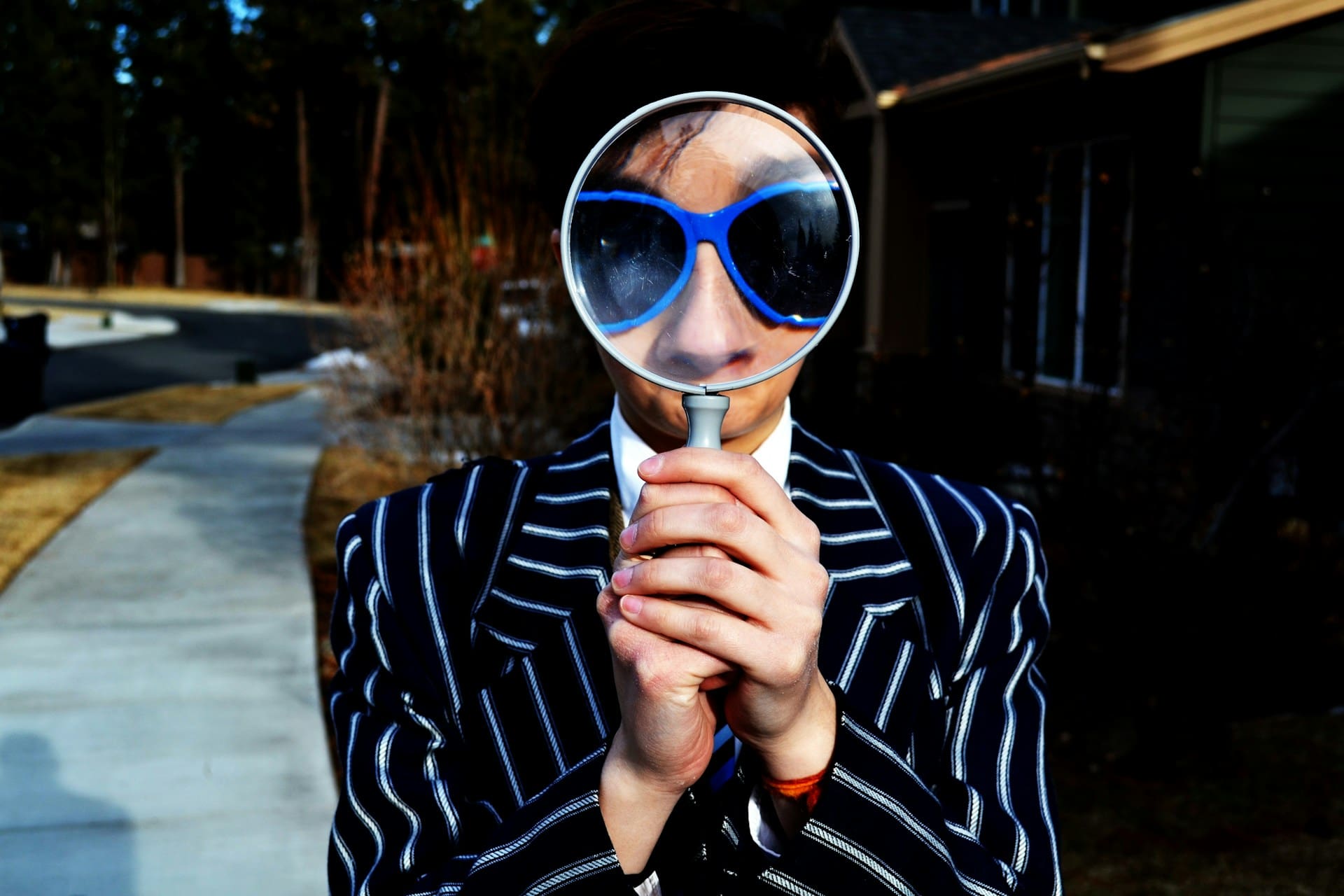 woman holding up a magnifying glass.